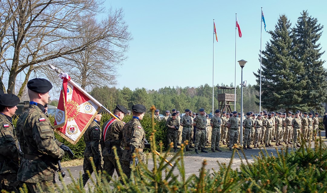 Armed Forces in parade, with flags.
